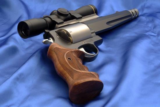 Smith & Wesson Magnum with optics (behind)