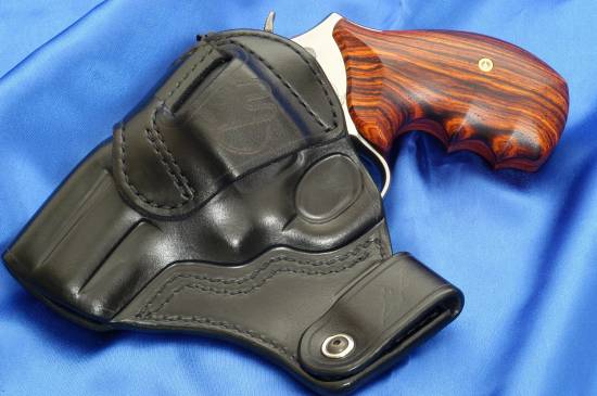 Smith & Wesson .357 Magnum in a holster (left)