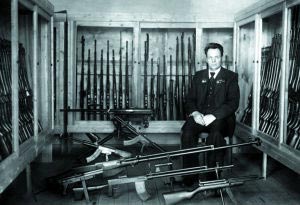 С.Г. Симонов на фоне коллекции своего оружия в НИИ-61. г. Климовск, 1953 г.